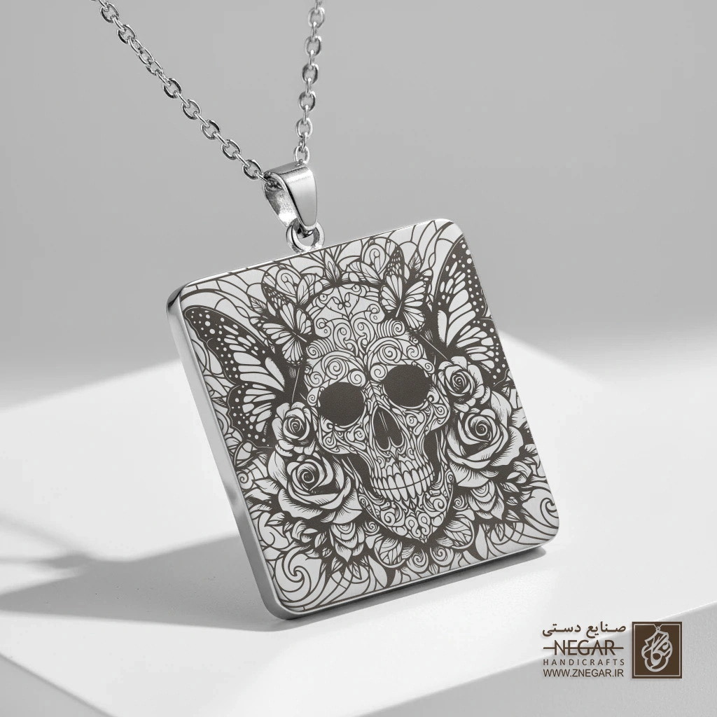 گردنبند طرح جمجمه و پروانه در میان رزها (حکاکی لیزری فایبر، مدل قاب مربع) کد 503062